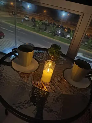 a table with two cups and a candle on it at Departamento frente al mar costa verde in Lima