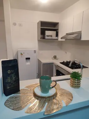 a coffee cup on a plate on a kitchen counter at Departamento frente al mar costa verde in Lima