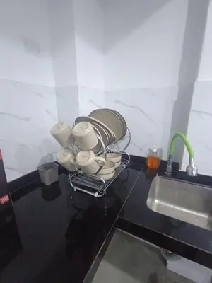 a bunch of cups on a counter next to a sink at IN FRONT OF THE NEW AIRPORT Hospedaje A y C - Taxi Free - Airport - Apartment Includes breakfast in Lima