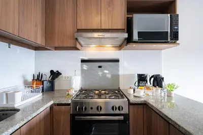 a kitchen with a stove and a microwave at Centric Apartments by Vibrant in Lima