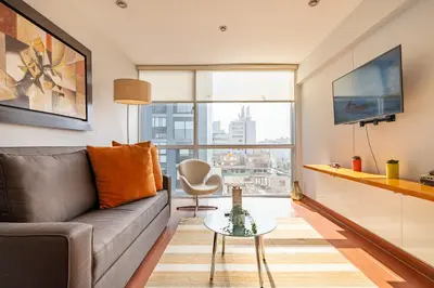 a living room with a couch and a table at Platino Apartments by Vibrant in Lima