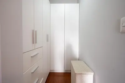 a bedroom with white cabinets and a stool at Platino Apartments by Vibrant in Lima