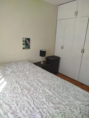 a bedroom with a large bed and white cabinets at Like a Home - Barranco in Lima