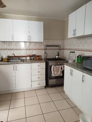 a kitchen with white cabinets and an oven at Like a Home - Barranco in Lima