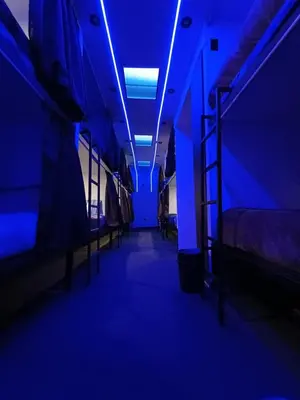 a blue room with beds and a ladder in it at Dream Up in Cusco