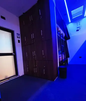 a room with dark cabinets and a blue light at Dream Up in Cusco