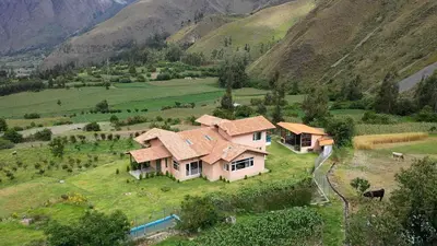 an aerial view of a house in a mountain at Urubamba Luxury Stay 