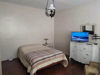 a bedroom with a bed and a television on a dresser at Amplio Departamento 2 dormitorios in Lima