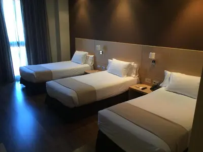 a hotel room with two beds and a window at Hotel PRADO'S in Satipo