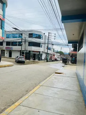 an empty street in a city with a building at Hotel PRADO'S in Satipo