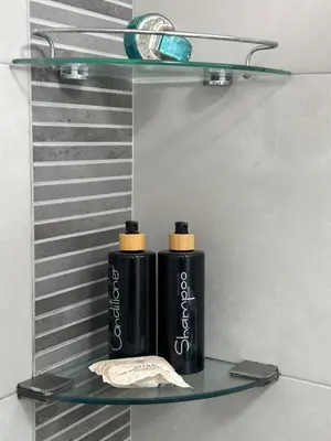 two black bottles sitting on a glass shelf at Duplex penthouse in Miraflores with terrace in Lima