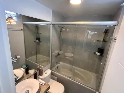 a bathroom with a shower and a toilet and a sink at Duplex penthouse in Miraflores with terrace in Lima