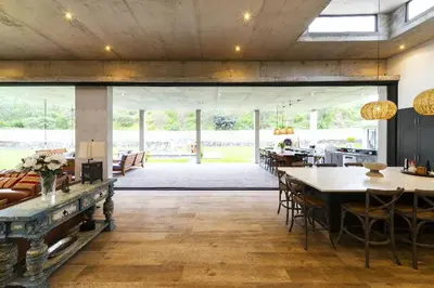 a dining room with tables and chairs and a large room at Casa de Campo en Cieneguilla in Cieneguilla