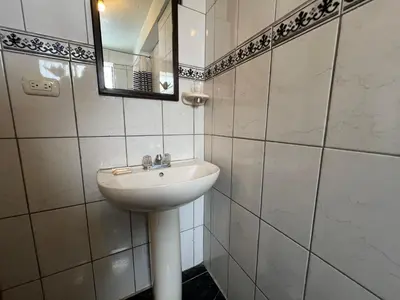 a bathroom with a sink and a mirror at Departamento a 5 cuadras de la Plaza de Armas Cusco in Cusco