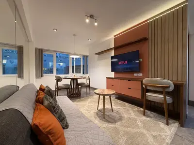 a living room with a couch and a flat screen tv at Boulevard Apartments by Vibrant in Lima