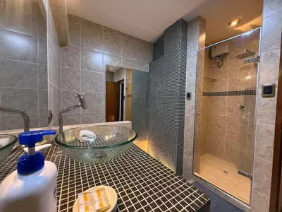 a bathroom with a glass tub and a shower at Boulevard Apartments by Vibrant in Lima