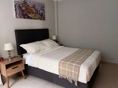 a bedroom with a bed and a nightstand with a bed sidx sidx sidx sidx at Misi House Hostal in Lima