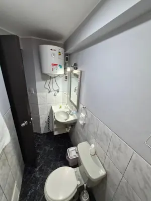 a small bathroom with a toilet and a sink at Apartamento Acogedor, tranquilo y privado in Lima