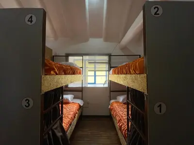 a room with three bunk beds with a window at Hostel - Cusco Dorms in Cusco