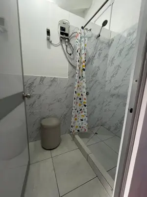 a bathroom with a shower with a shower curtain at Hostel - Cusco Dorms in Cusco