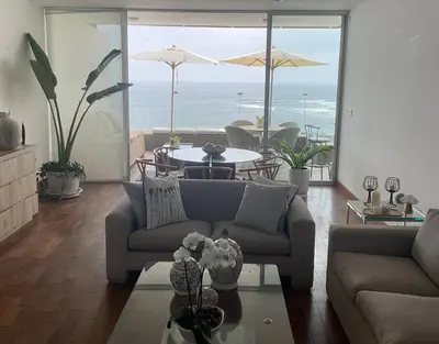 a living room with a couch and a table at Punta Hermosa in Punta Hermosa