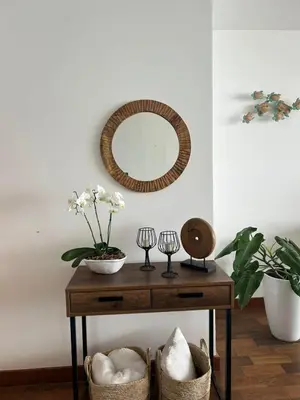 a table with a mirror and a plant and baskets at Punta Hermosa in Punta Hermosa