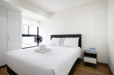 a bedroom with a large white bed and a window at Aquilarias Apartments by Vibrant in Lima