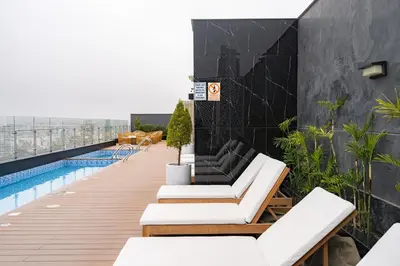 a balcony with white furniture and a swimming pool at Artline Apartments by Vibrant in Lima