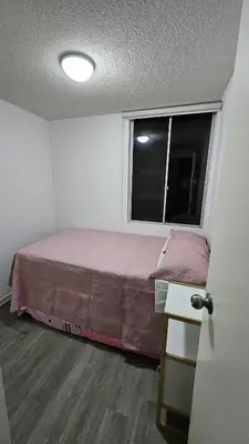 a small bedroom with a bed and a window at Ocean Sunset vista al mar, piscina y balcón in Lima