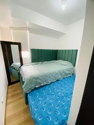 a bedroom with a bed with blue sheets and a mirror at Moderno Smart Home San Miguel - Self check in in Lima