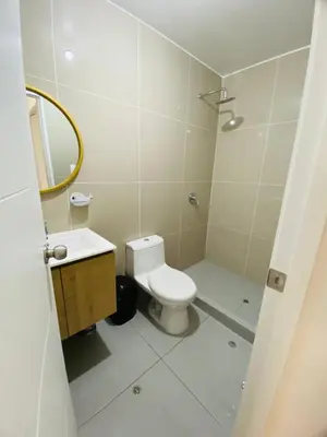 a white bathroom with a toilet and a sink at Moderno Smart Home San Miguel - Self check in in Lima