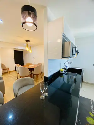 a kitchen and dining room with wine glasses on a counter at Moderno Smart Home San Miguel - Self check in in Lima