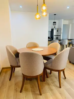 a dining room with a wooden table and chairs at Moderno Smart Home San Miguel - Self check in in Lima