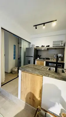a large kitchen with a counter in a room at Luxury mini, beautiful tip in Punta Hermosa