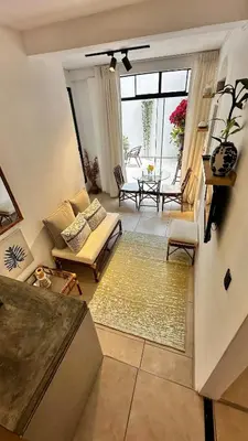 a living room with a couch and a table at Luxury mini, beautiful tip in Punta Hermosa