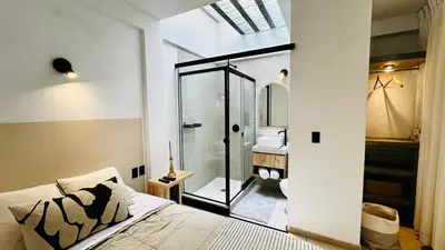 a bedroom with a bed and a bathroom with a shower at Luxury mini, beautiful tip in Punta Hermosa