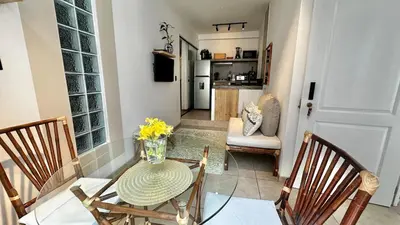 a dining room with a table and chairs and a kitchen at Luxury mini, beautiful tip in Punta Hermosa
