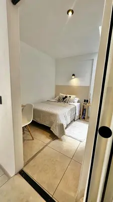 a bedroom with a bed in a white room at Luxury mini, beautiful tip in Punta Hermosa