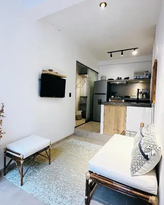 a living room with a couch and a kitchen at Luxury mini, beautiful tip in Punta Hermosa