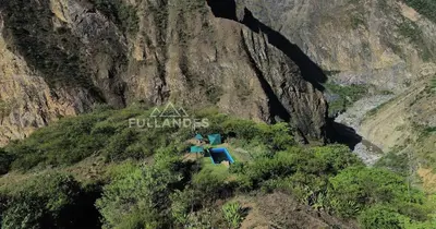 a group of people sitting on top of a mountain at Casitas Choquequirao Chikiska in Abancay