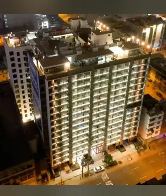 an aerial view of a tall building at night at Habitación privada en departamento compartido in Lima