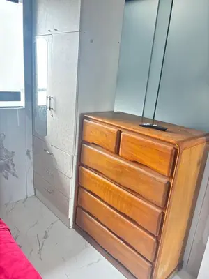 a wooden dresser sitting in a bedroom with at Cuarto privado en departamento compartido in Lima