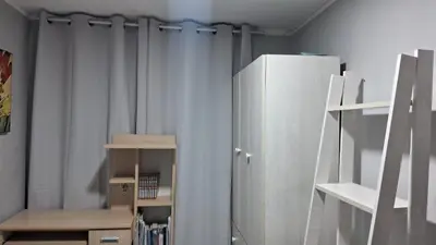 a room with a curtain and a refrigerator at Relax Department in Lima