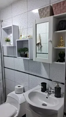 a bathroom with a sink and a toilet and a mirror at Relax Department in Lima