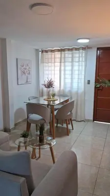 a living room with a table and chairs at Relax Department in Lima