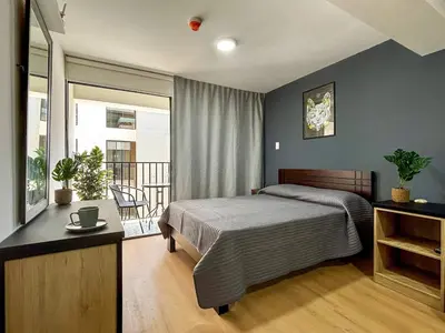 a bedroom with a bed and a balcony at New and modern flat in Barranco & Miraflores in Lima