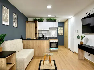 a living room with a couch and a kitchen at New and modern flat in Barranco & Miraflores in Lima