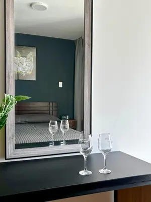 three wine glasses sitting on a counter in front of a mirror at New and modern flat in Barranco & Miraflores in Lima