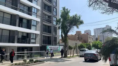 a group of people walking down a street next to a building at New and modern flat in Barranco & Miraflores in Lima