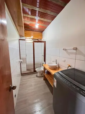 a bathroom with a toilet and a sink and a shower at Hassinger Haus in Oxapampa